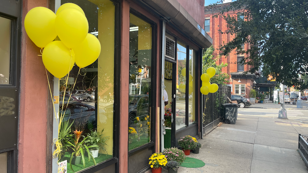 Storefront with yellow balloons