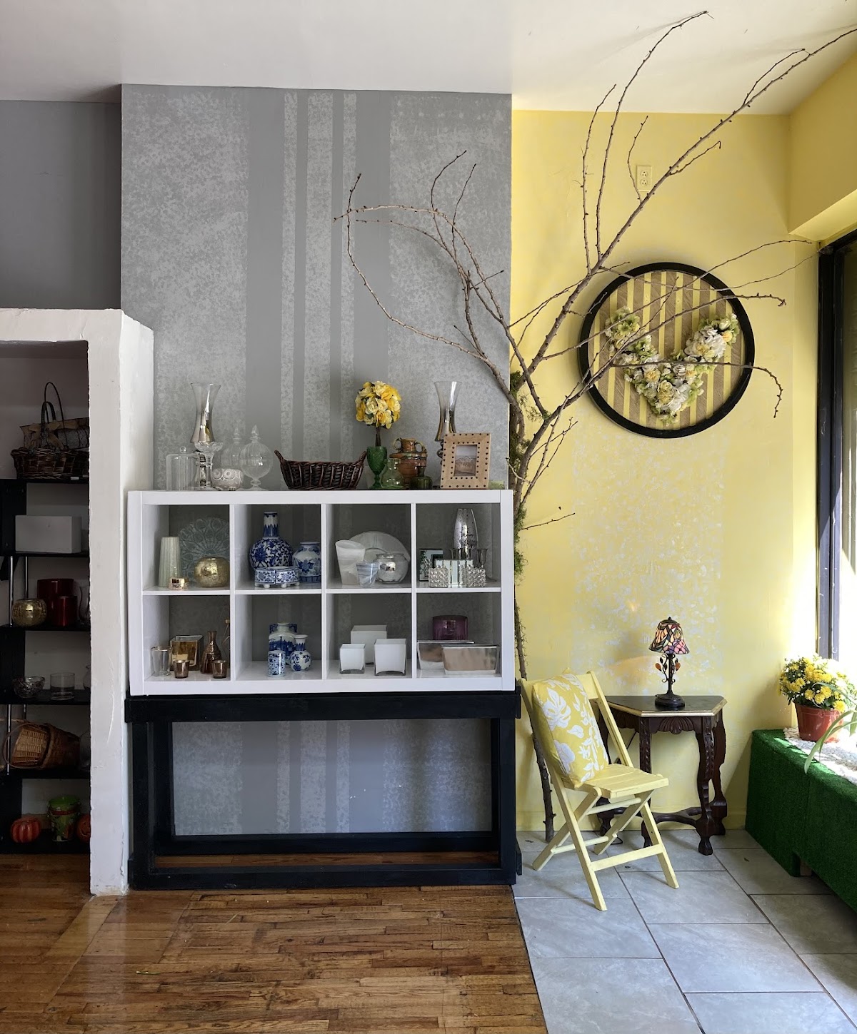 Verdure shop interior, yellow accent wall and gallery shelving