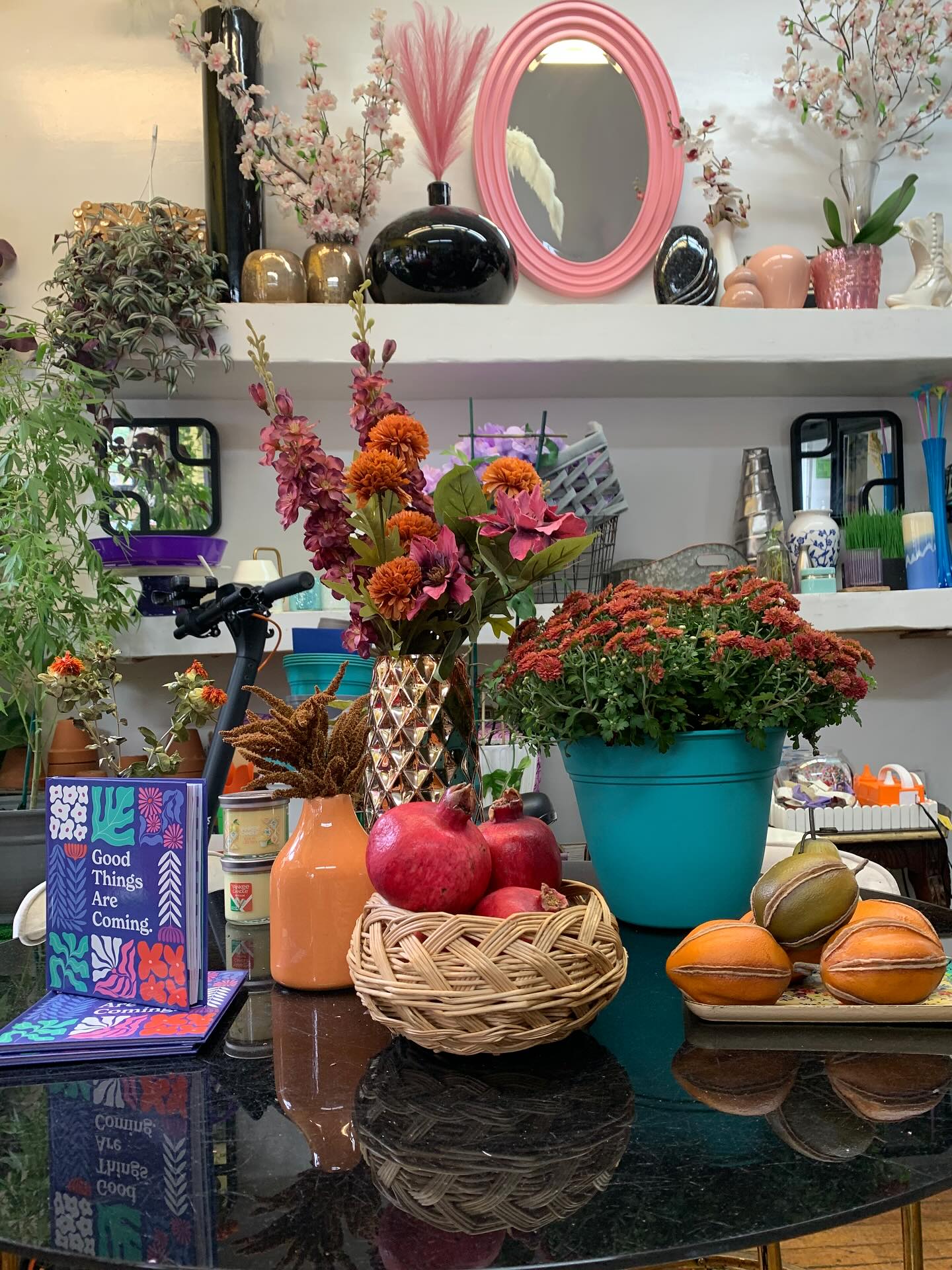 Editorial styled tabletop with mums, dahlias and citrus